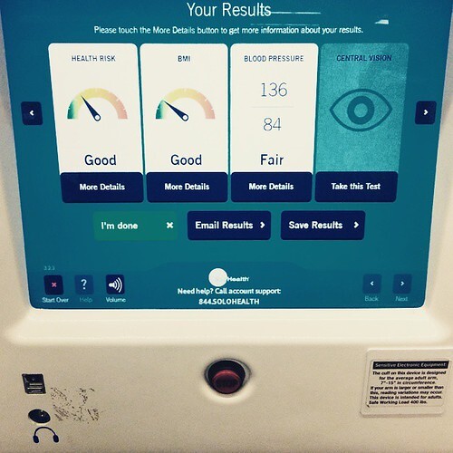 A woman walking down the street in front of a cafe